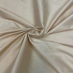 "Close-up of a Beige faux silk fabric with a smooth and shiny texture. Faux silk is a synthetic alternative to real silk, offering a similar luxurious look and feel, perfect for various fashion and home decor applications."