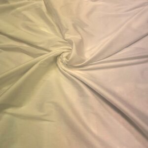 "Close-up of a Cream faux silk fabric with a smooth and shiny texture. Faux silk is a synthetic alternative to real silk, offering a similar luxurious look and feel, perfect for various fashion and home decor applications."