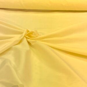 "Close-up of a gold faux silk fabric with a smooth and shiny texture. Faux silk is a synthetic alternative to real silk, offering a similar luxurious look and feel, perfect for various fashion and home decor applications."