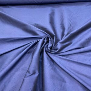"Close-up of a faux silk Navy fabric sample in a neutral beige color, showing its smooth and shiny texture. Faux silk is a synthetic alternative to real silk, offering a similar luxurious look and feel."