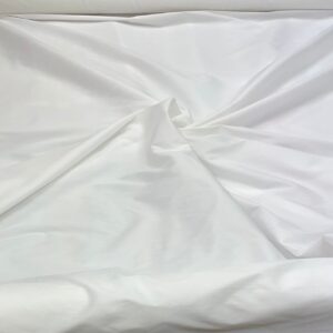"Close-up of a White faux silk fabric with a smooth and shiny texture. Faux silk is a synthetic alternative to real silk, offering a similar luxurious look and feel, perfect for various fashion and home decor applications."