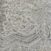 "Close-up view of Double Scalloped Bridal Lace - intricately embroidered and adorned with sequins, adding a touch of timeless elegance to a wedding gown."